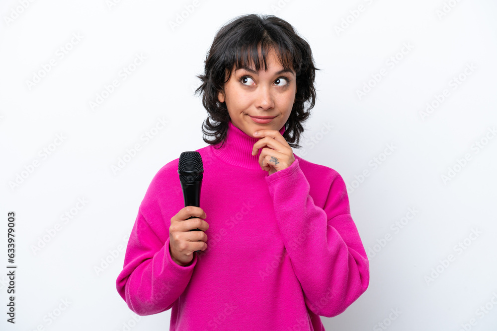 Young Argentinian singer woman isolated on white background and looking up Young Argentinian singer woman isolated on white background and looking up
