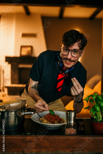 Portrait of a male chef prepares a fresh pasta spaghetti at home