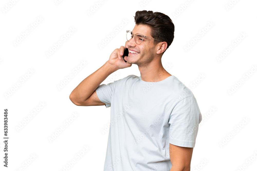 Young caucasian handsome man over isolated background keeping a conversation with the mobile phone with someone Young caucasian handsome man over isolated background keeping a conversation with the mobile phone with someone