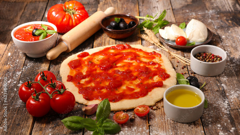 Raw dough preparation or pizza with ingredient: tomato sauce, olive oil, mozzarella and basil