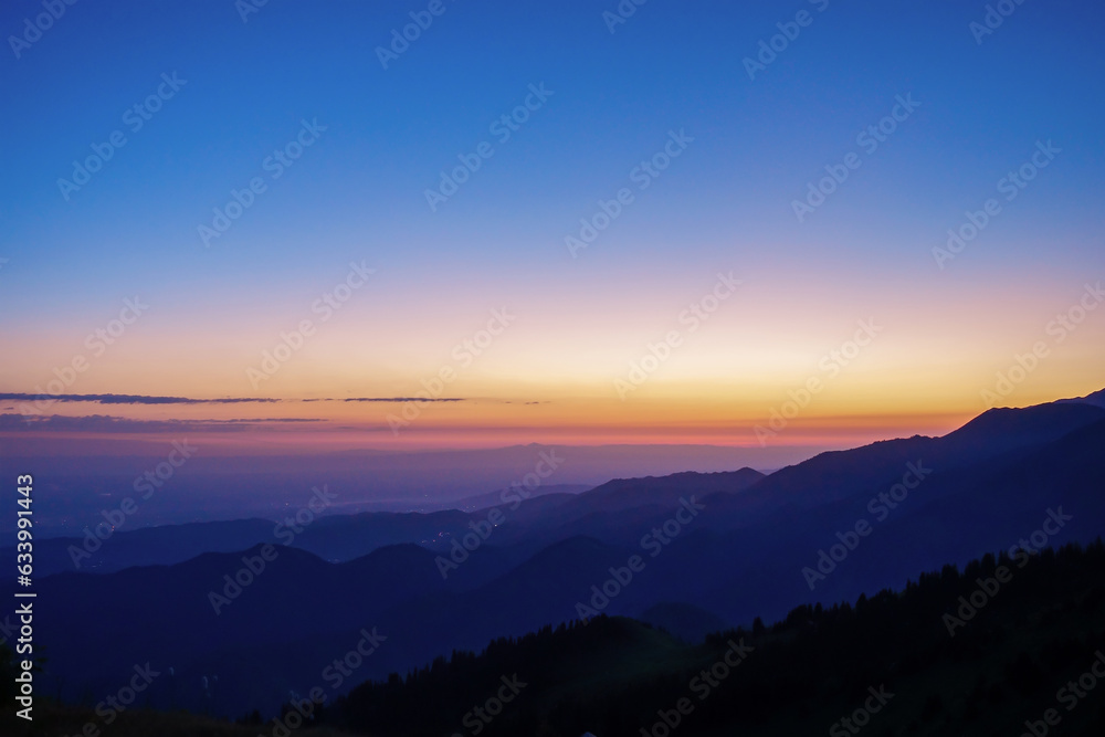 Silhouettes of mountain ranges in the early morning