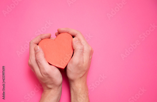 Giving a heart, hand gives a valentine. Concept of valentine's day, declaration of love