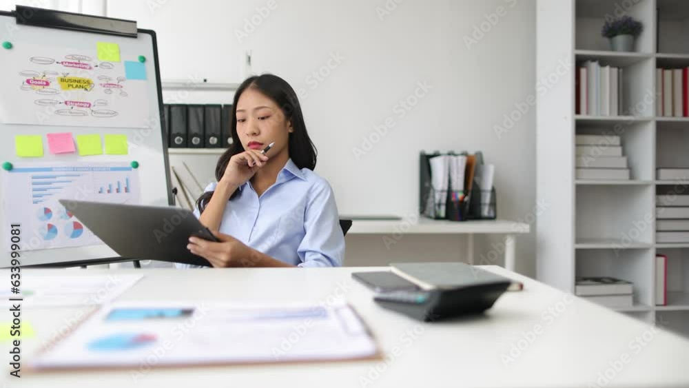 Businesswoman reading documents while working on accounting paperwork and analyzing financial budgets in the office. Businesswoman reading documents while working on accounting paperwork and analyzing financial budgets in the office.