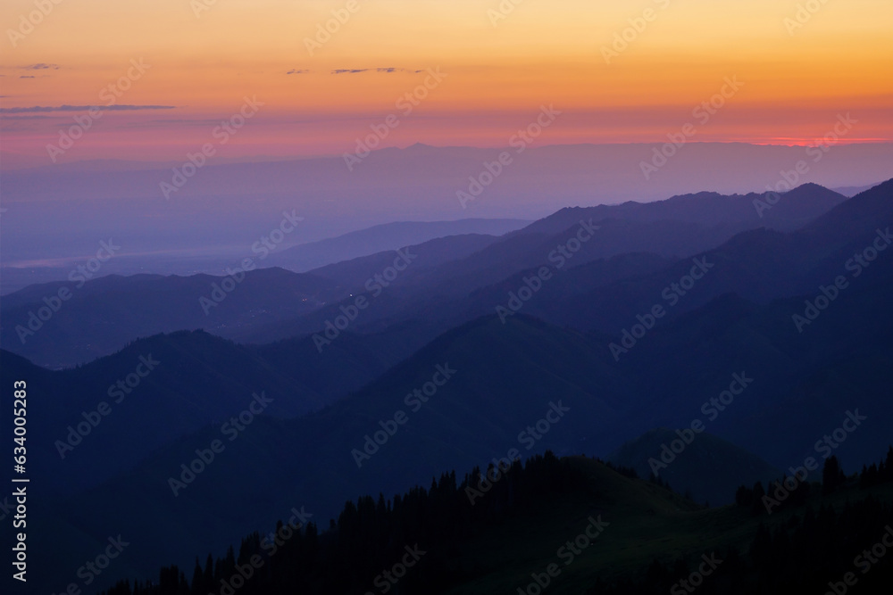 Silhouettes of mountain ranges in the morning haze