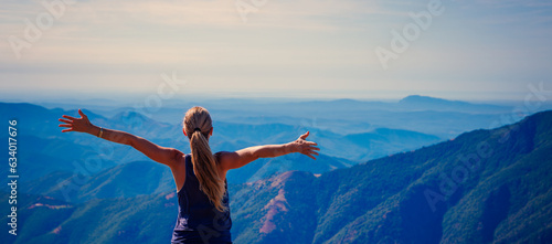 travel, tourism, adventure, sport concept- Woman on top of mountain