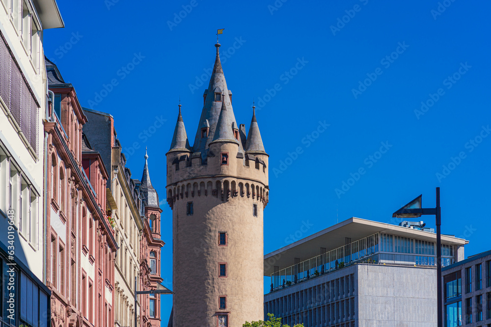 Tradition and modernity meet in Frankfurt am Main Innenstadt District. View of Eschenheimer Tower medieval city gate. 