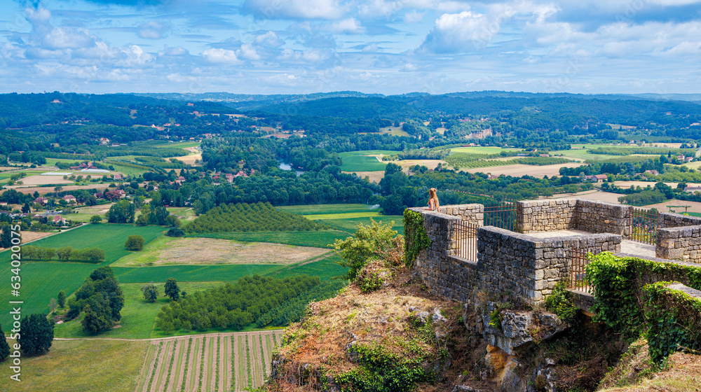 Naklejka premium Beautiful panoramic landscape with field and meadow view with woman enjoying at the viewpoint- travel, tour tourism in France- Dordogne, Perigord