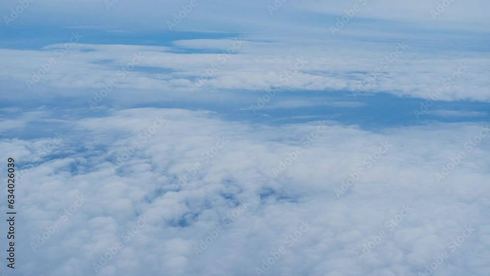 Top view of Blue sky with white fluffy cumulus clouds. Panorama of white fluffy clouds in the blue sky. Beautiful vast blue sky with amazing scattered cumulus clouds. View from the plane window. Top view of Blue sky with white fluffy cumulus clouds. Panorama of white fluffy clouds in the blue sky. Beautiful vast blue sky with amazing scattered cumulus clouds. View from the plane window.