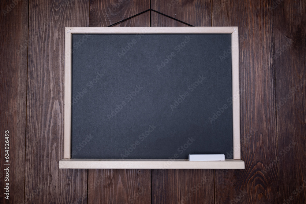 School grade. Small blackboard with chalk on wooden wall School grade. Small blackboard with chalk on wooden wall