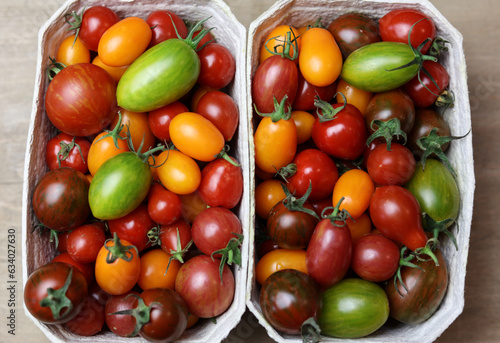 a variety of fresh multicolored tomatoes on a wooden table