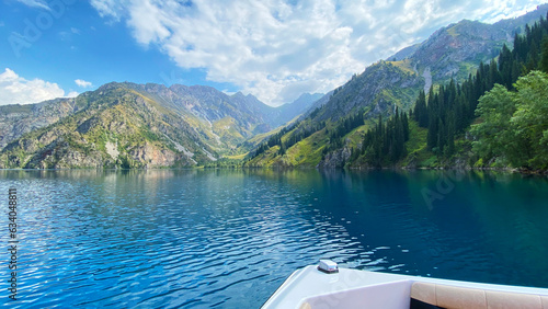 Boat trip on the beautiful mountain lake of Sary Chelek. The State Biosphere Reserve is a specially protected natural territory of Kyrgyzstan. photo