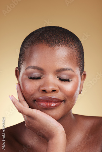 Beauty, natural makeup and face a black woman in studio for skincare, glow and cosmetics. Headshot of African person with facial shine, dermatology and self care for wellness on beige background