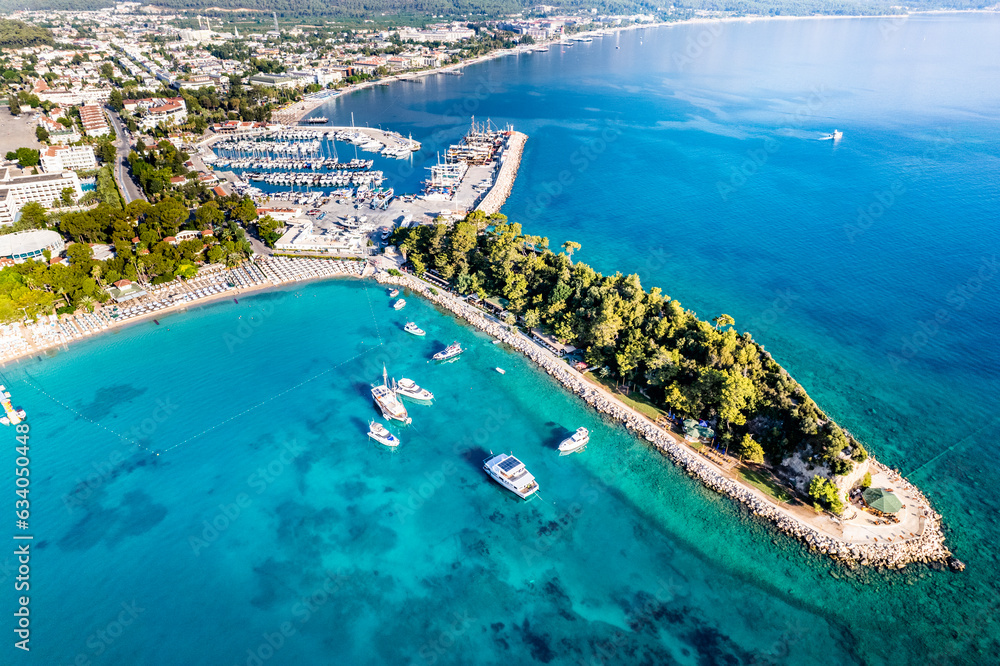 Fototapeta premium Kemer, Antalya, Turkey. Aerial view of Kemer Marina. Beautiful turquoise colors of Mediterranean sea. Drone shot.