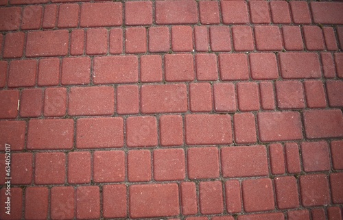 colored tiles in dark red color under the background for asphalt tiles
