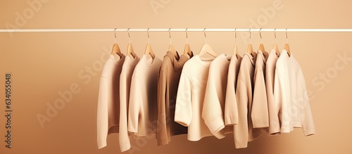 Empty space with minimal background featuring a collection of feminine beige sweaters perfect for autumn and winter fashion