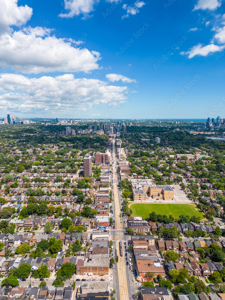 Immerse yourself in a breathtaking capture of Saint Clair in Downtown Toronto, where urban vibrancy meets the ethereal. This imagery contrasts the city's iconic structures with expansive, clear skies,