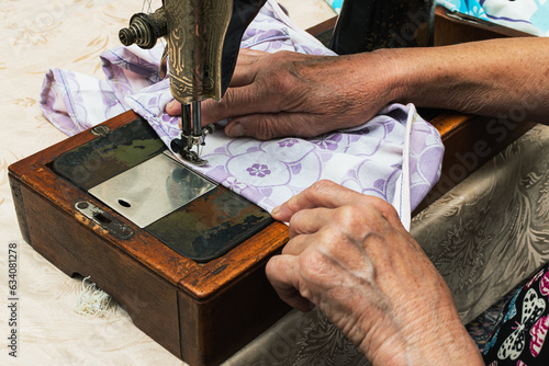 Sewing fabric at home on an old sewing machine