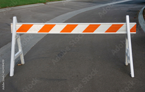 Red and white striped temporary road barrier