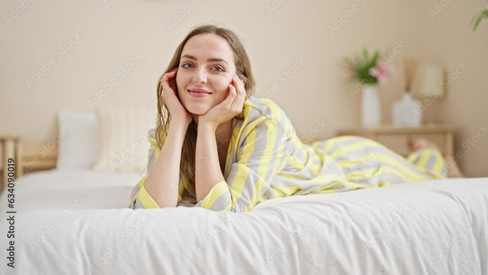 Young blonde woman smiling confident lying on bed at bedroom Young blonde woman smiling confident lying on bed at bedroom