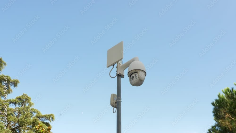 Modern surveillance camera. CCTV. Moving security camera on pole. Public place and streets security concept Modern surveillance camera. CCTV. Moving security camera on pole. Public place and streets security concept