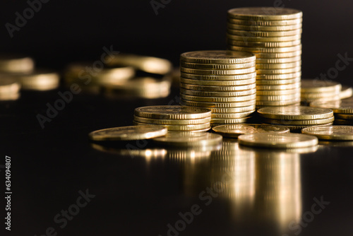 Wallpaper Mural close up stack of golden money coin on black background with selective focus. Business and financial concept.  Torontodigital.ca