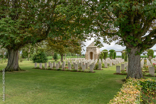 Ryes, France - 07 24 2023: Bazenville British Military Cemetery. View of Memorial and the white tombstones of soldiers.