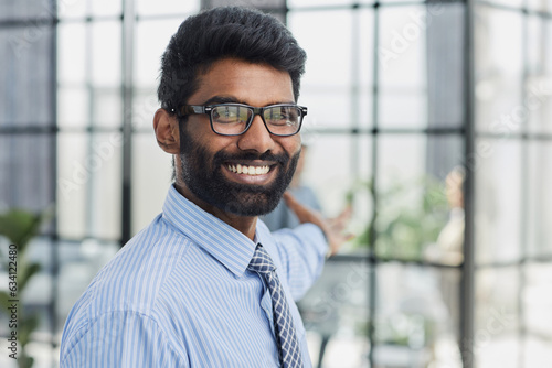 Close-up photo portrait of successful and happy businessman, male investor beard looking at camera