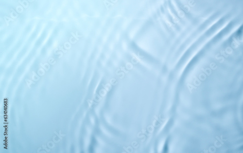 Take a picture of the clear blue water surface with ripples.