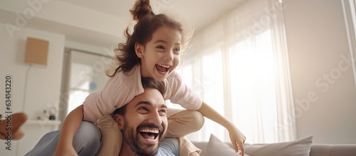 Obraz na płótnie Middle eastern family playing together at home cheerful dad lifting up his joyful girl playing airplane copy space w salonie