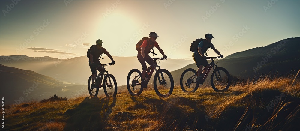 Obraz premium Three friends on electric bicycles enjoying a scenic ride through beautiful mountains