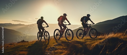 Three friends on electric bicycles enjoying a scenic ride through beautiful mountains