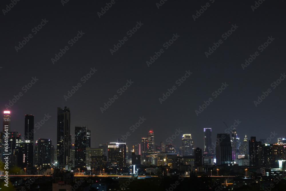 Bangkok, Thailandland - 9 Aug 2023: Panoramic Bangkok skyline view, concrete observatory deck rooftop, night time. Asian corporate and residential lifestyle. Financial city downtown, real estate. 