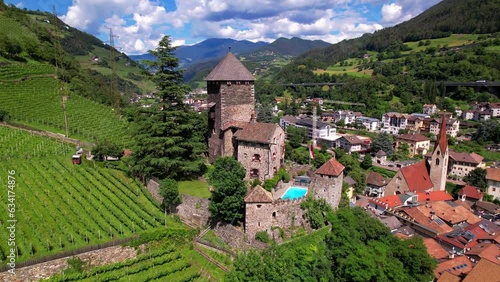 Scenic beautiful places of northern Italy. Charming village Chiusa with castle Branzoll surrounded by Dolomites mountains. arerial view. Valle Isarco, in Trentino Alto Adige, Bolzano province photo