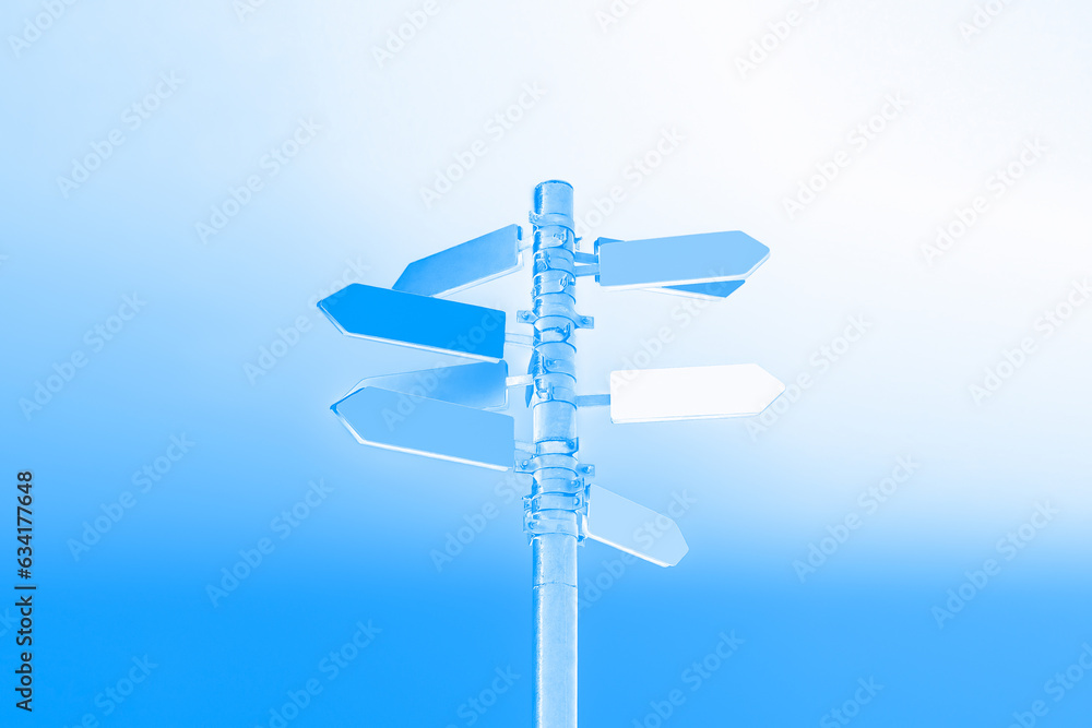 Guidepost with arrows illuminated by a beautiful blue light Guidepost with arrows illuminated by a beautiful blue light