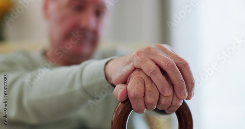 Elderly man, hands and walking stick or wood cane on sofa for balance, support or mobility in retirement or nursing home. Senior patient, closeup and old person with a disability or arthritis aid photo