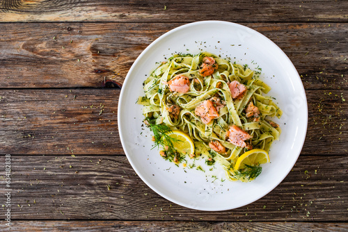 Tagliatelle with salmon and dill on wooden table
 photo