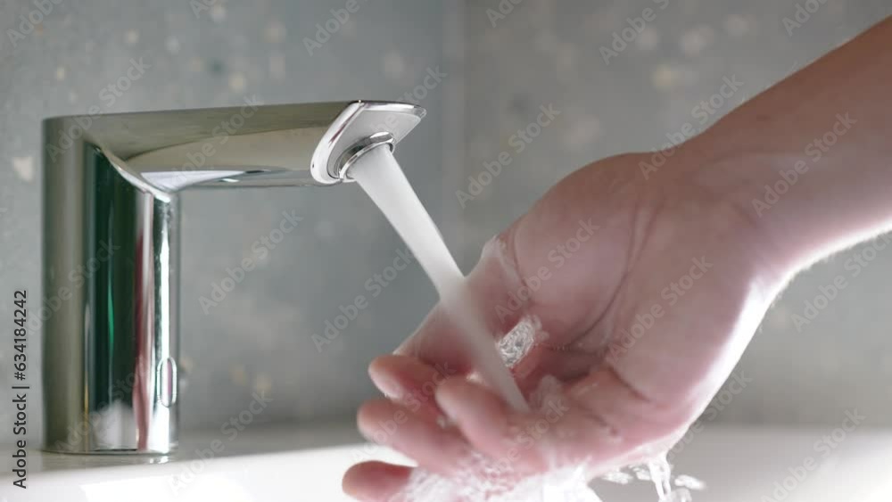 Close up male hand open the faucet of water in the toilet. The faucet
