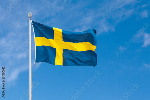 Swedish flag waving atop of its pole