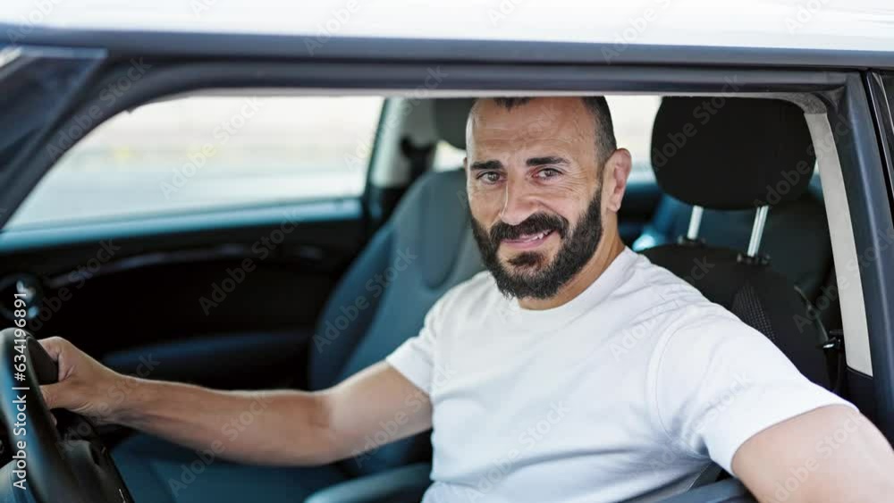Young hispanic man smiling confident holding key of new car at street Young hispanic man smiling confident holding key of new car at street