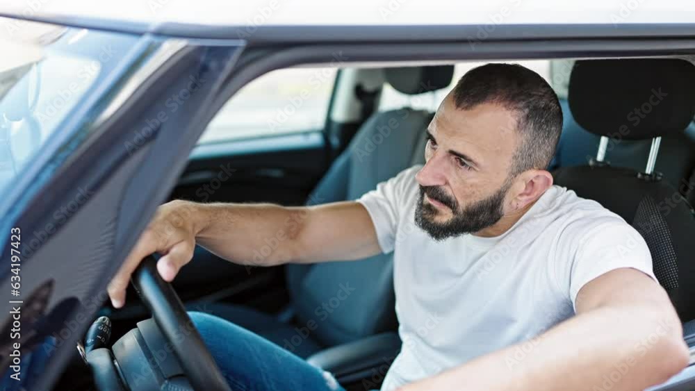 Young hispanic man stressed driving car screaming at street Young hispanic man stressed driving car screaming at street
