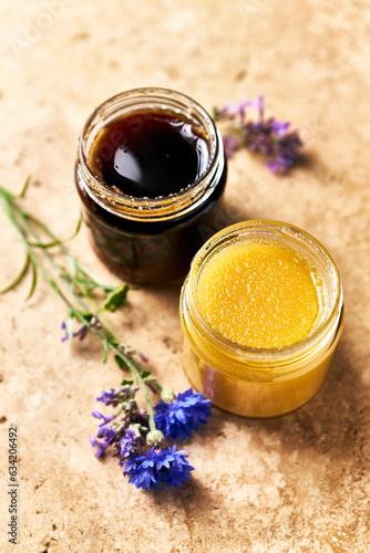 Two jars of organic natural honey. Multifloral and buckwheat honey. Healthy food ingredients. Copy space