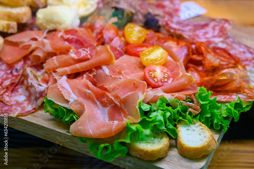 Fresh cuts of French cured sausages, ham, cheeses for party close up