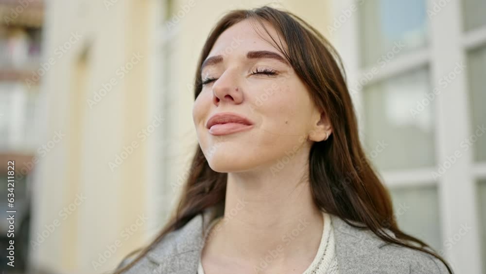 Young hispanic woman smiling breathing at street Young hispanic woman smiling breathing at street