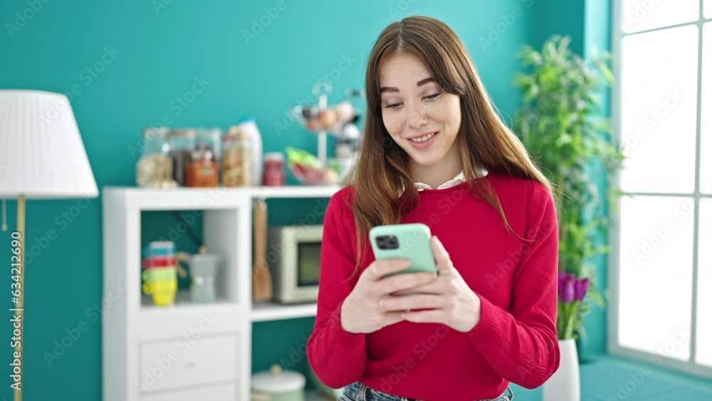 Young hispanic woman using smartphone standing at dinning room Young hispanic woman using smartphone standing at dinning room