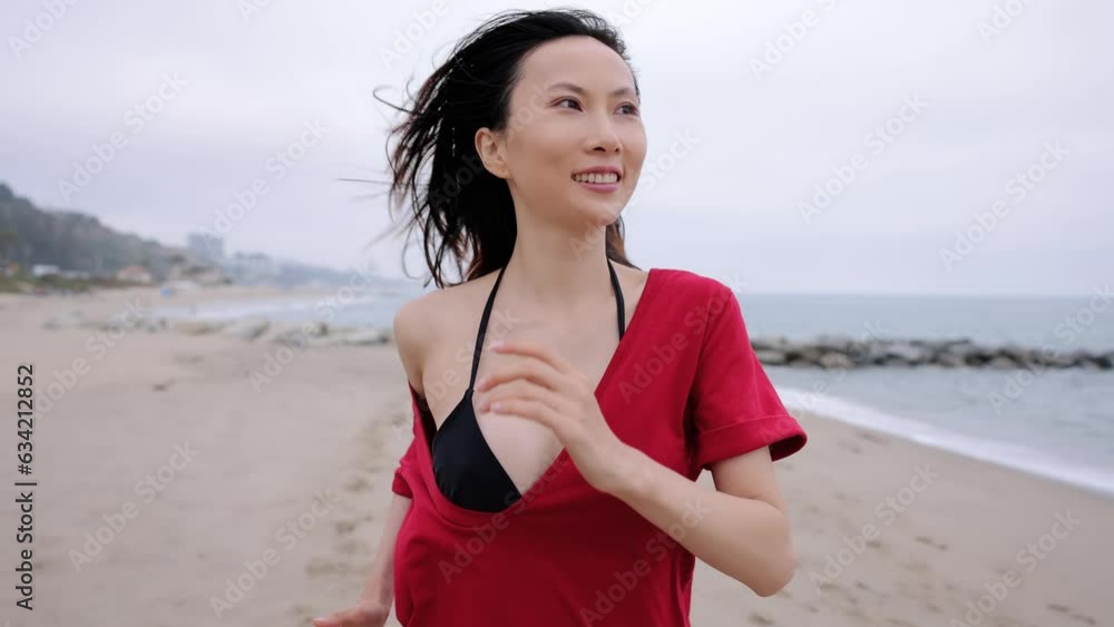 Attractive Asian woman running on the beach in Santa Monica California. Slow Motion. Attractive Asian woman running on the beach in Santa Monica California. Slow Motion.