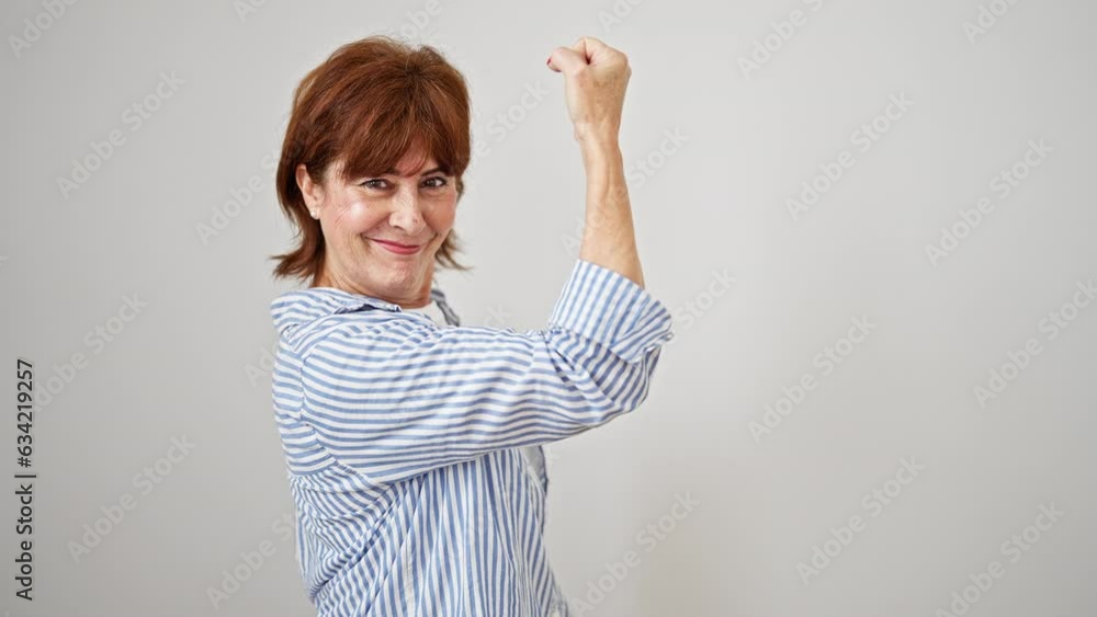 Middle age woman smiling confident doing strong gesture with arm over isolated white background Middle age woman smiling confident doing strong gesture with arm over isolated white background