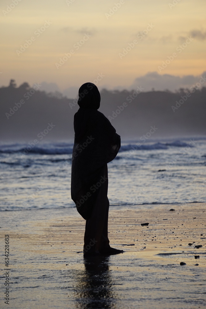 Lonely girl enjoy luxury sunset on the beach during summer vacations