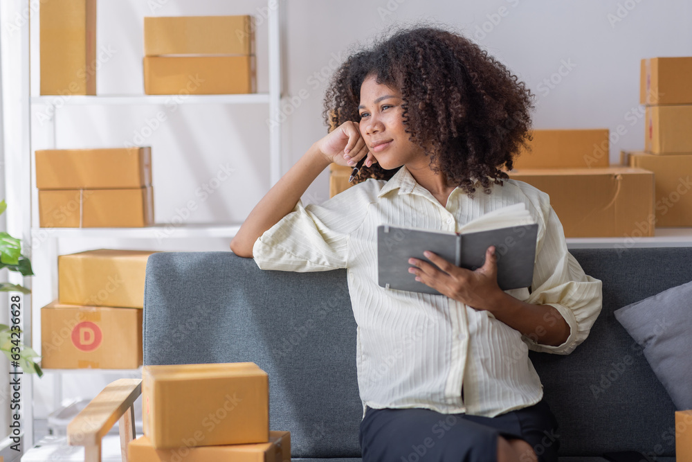 Small business entrepreneur SME freelance pregnant african woman work from home her hand holding credit card with box, online marketing packaging mail box and delivery, SME e-commerce concept Small business entrepreneur SME freelance pregnant african woman work from home her hand holding credit card with box, online marketing packaging mail box and delivery, SME e-commerce concept