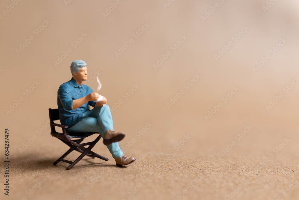 Miniature people drinking hot coffee and space for text ,International coffee day concept