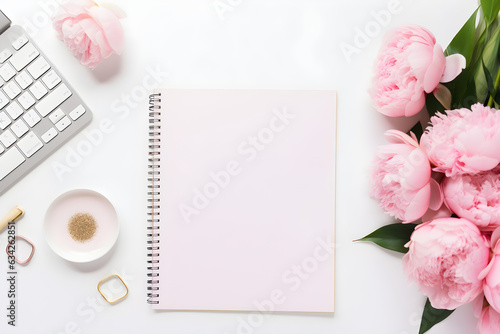 Fototapeta Naklejka Na Ścianę i Meble -  feminine workspace / desk with blank open notepad, keyboard, stylish office / writing supplies and pink peonies on a white background